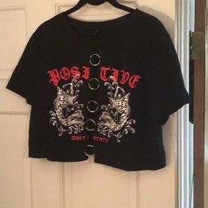 Half shirt w/5 rings in front and the back is closed.